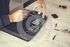 Man hand laptop disassembling