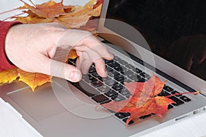 Man hand on laptop keyboard with blank screen monitor
