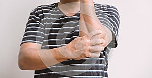 Man hand massage physiotherapy elbow is sore and numb, exhausted, tingling. Guillain-Barre Syndrome, a side effect of the Covid-19