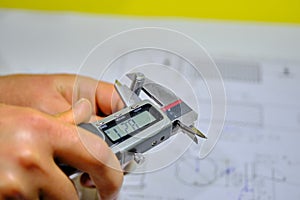A man hand measuring the M8 bolt bonding fastener