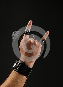 Man hand with microphone  on black