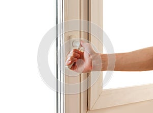 Man hand opens the white plastic the window. Isolated on white