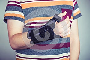 Man with hand in orthopedic black orthosis