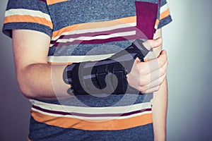 Man with hand in orthopedic black orthosis