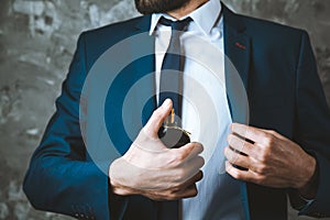 Man hand perfume on dark background