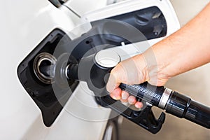 Man hand with petrol pump buying gasoline