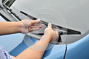 Man hand picking up windscreen wiper