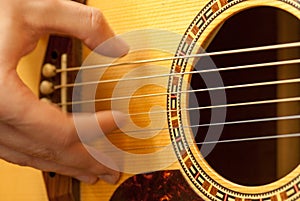 Man hand playing acoustic guitar strings recreation concept