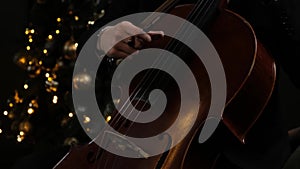 Man Hand Playing cello With Cello Bow. Close up of Male Hand Playing Cello With Cello Bow. Classical Orchestra Musician