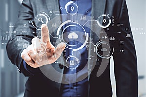 Man hand pointing at abstract business interface on blurry background. Cloud computing, technology and database concept. Double