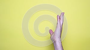 man hand pointing at someone over yellow background
