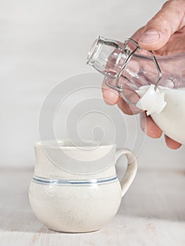 Man hand pouring milk from bottle