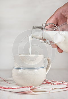 Man hand pouring milk from bottle