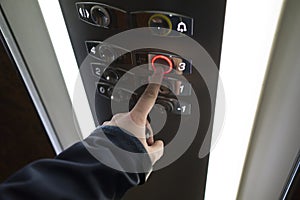 Man hand pressing button on elevator