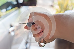 Man hand pressing car remote control