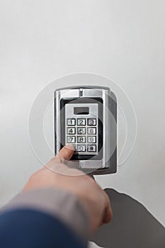 Man hand pressing security code combination to unlock the door or safe