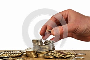 Man hand put money coins to stack of coins. Money savings, investment, financial wealth management concept