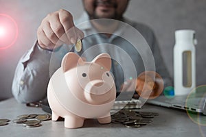 Man hand putting coin in piggy bank, financial plan and Money saving ideas
