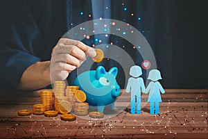 Man hand putting golden money coin into blue piggy bank for saving money, concept of saving to wedding, travel and buy a house.