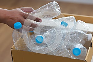 man hand putting plastic reuse for recycling concept environmen