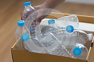 man hand putting plastic reuse for recycling concept environmen