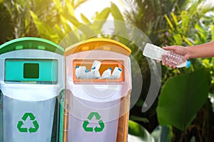 man hand putting plastic reuse for recycling concept environmen