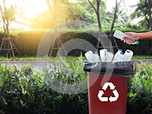 man hand putting plastic reuse for recycling concept environment