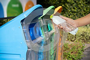 man hand putting plastic reuse for recycling concept environment