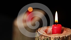 Man hand set on fire on candles in wooden candlestick black background