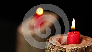 Man hand set on fire on candles in wooden candlestick black background