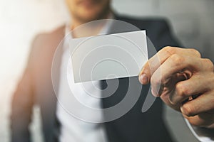 Man hand showing blank business card in front