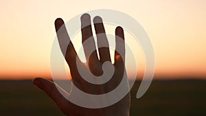 man hand silhouette sunlight. Muslim with man hand sun on light background. christian business love religion concept