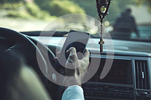 Man hand smart phone in car