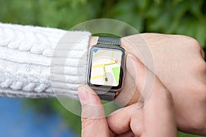 Man hand and smart watch with map in the screen