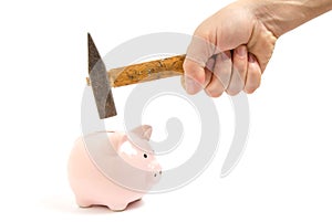 Man hand smashes a pink piggy Bank on a white background with a hammer