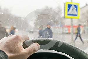 Man hand on the steering wheel of the car