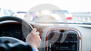 Man hand on steering wheel inside of a car