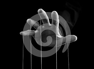 Man hand with strings on fingers. Manipulation, power concept. Male making person feel fear, obligation, guilt. Black
