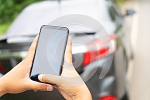 Man Hand Taking Photo Of Car Accident Through Smartphone, close up..Insurance agent using smart phone to take a photo