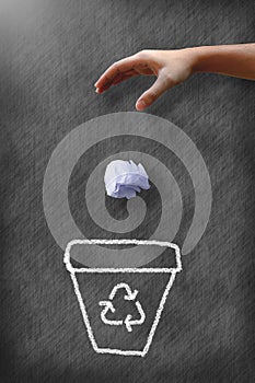 Man hand throwing wastepaper to recycle bin photo