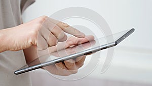 Man hand touching screen on modern digital tablet pc