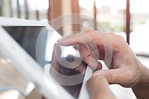 Man hand touching screen on modern digital tablet pc. Close-up i