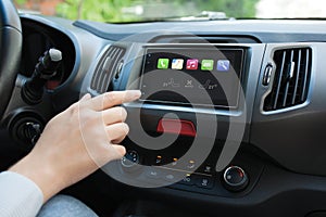 Man hand touching to screen multimedia system with Auto Play