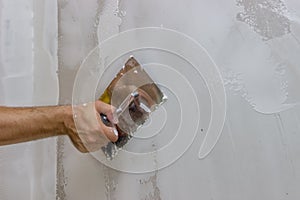 Man hand with trowel plastering a wall 3