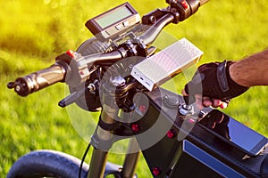 Man hand turning ignition key on ebike