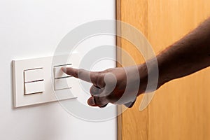 Man hand turning on the light