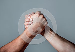 Man hand. Two men arm wrestling. Arms wrestling. Closep up. Friendly handshake, friends greeting, teamwork, friendship