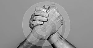Man hand. Two men arm wrestling. Arms wrestling. Closep up. Friendly handshake, friends greeting, teamwork, friendship