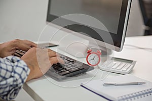 Man hand typing on the keyboard working in office. Business concept