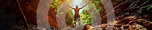 A man with hand up jumping on the top of the mountain